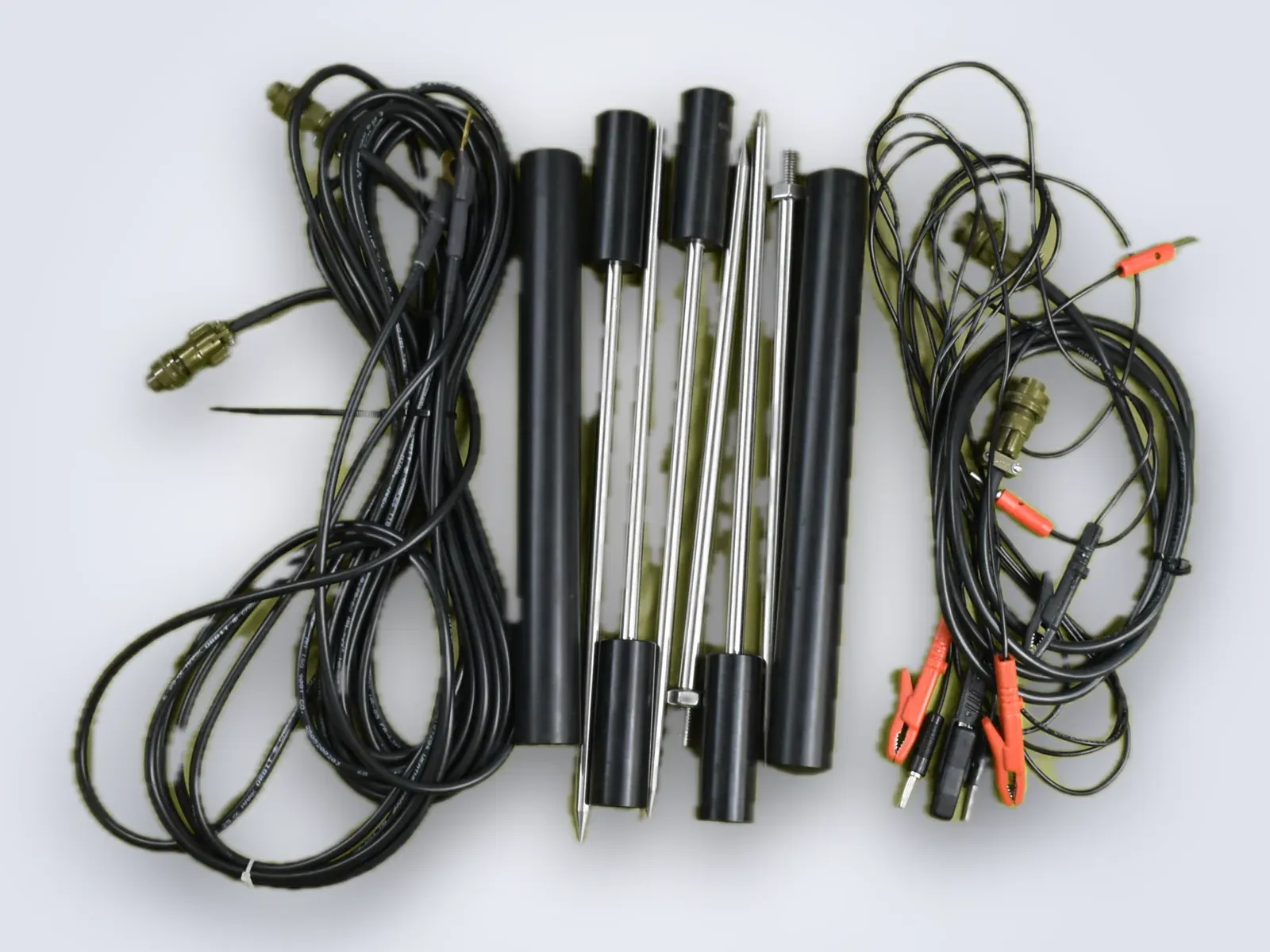 Survey cables, four stainless electrode rods with insulated grips, connectors and clips laid out flat